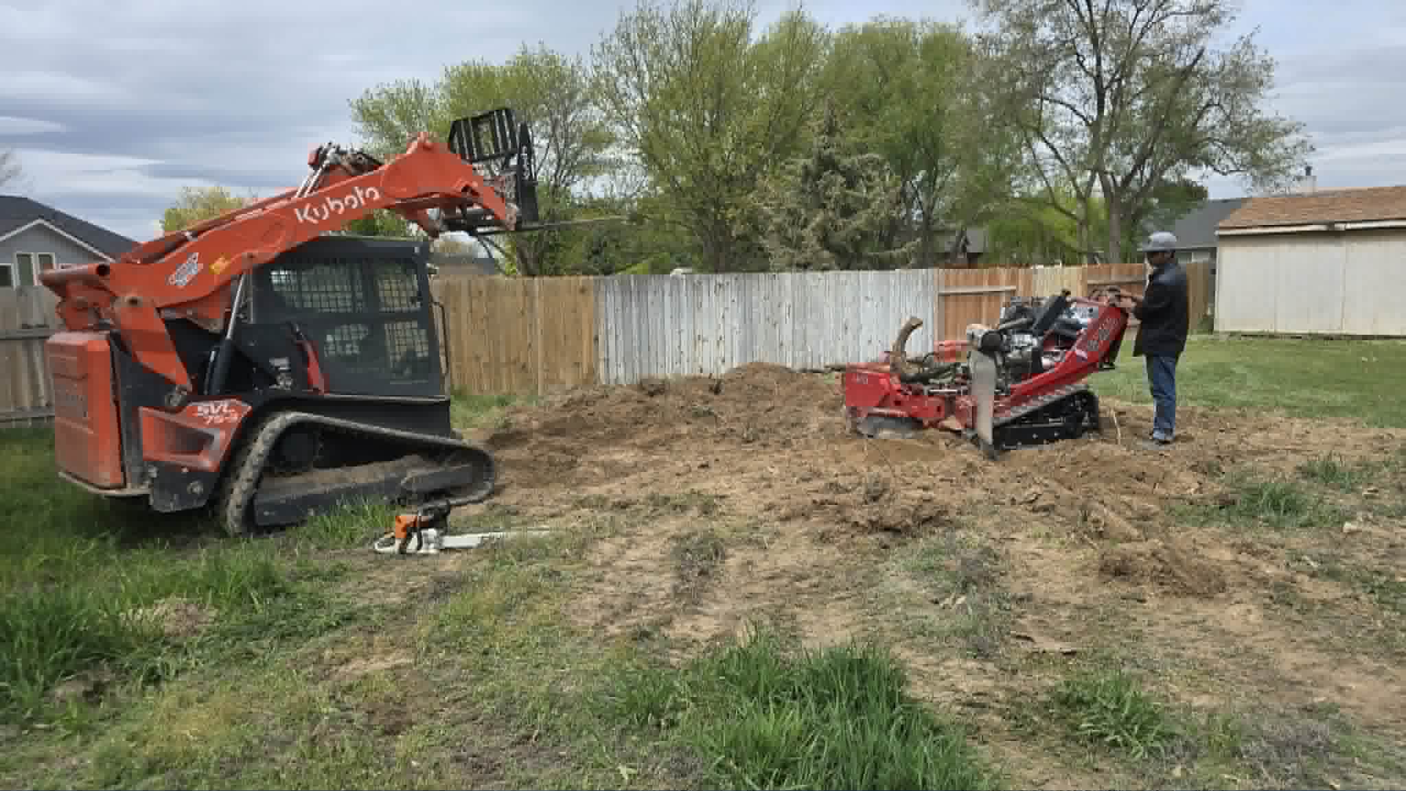 Compact track loader and tree equipment at a residential jobsite